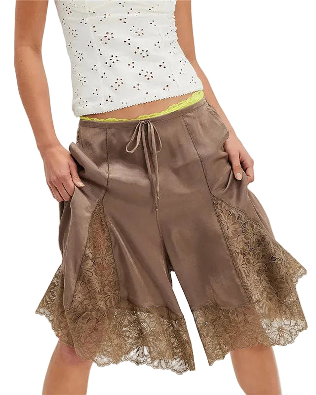 Brown lace-trimmed shorts worn by a person on a white background
