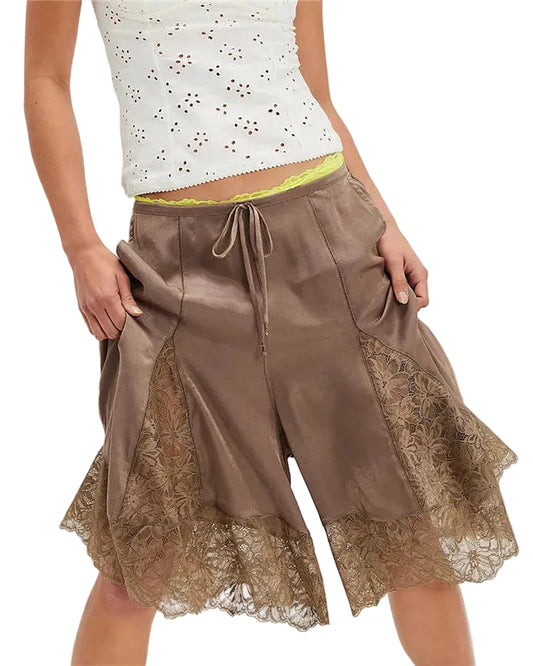 Brown lace-trimmed shorts worn by a person on a white background